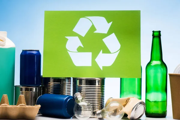 Different types of trash with recycle sign — Stock Photo