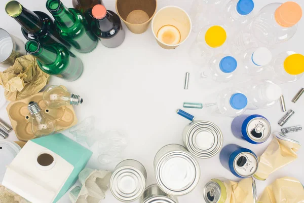 Top view of round frame of different types of trash on white — Stock Photo