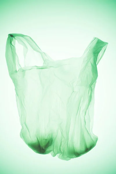 Empty transparent plastic bag under green toned light — Stock Photo