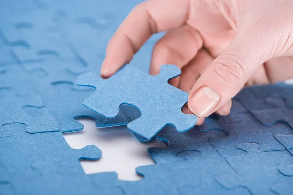 Cropped image of businesswoman inserting last missing puzzle, business concept — Stock Photo