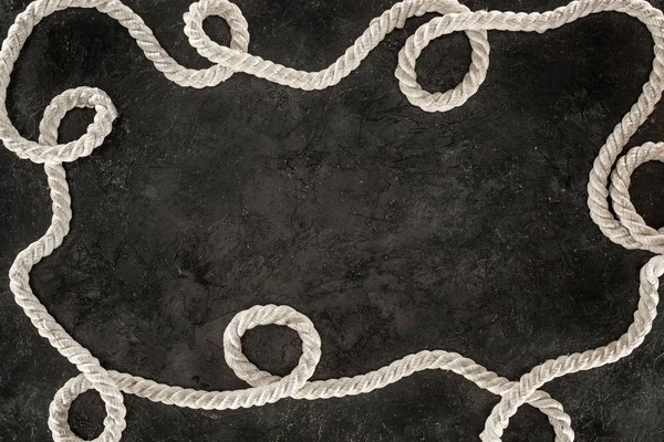 Top view of white nautical rope on dark concrete tabletop — Stock Photo