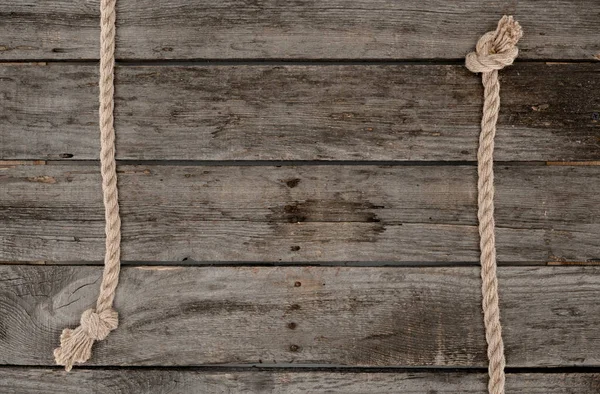 Flat lay with marine ropes with knots on grunge wooden tabletop — Stock Photo