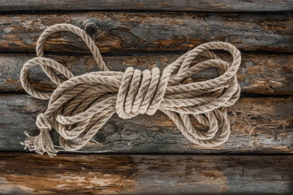 Top view of tied nautical rope on grunge wooden surface — Stock Photo