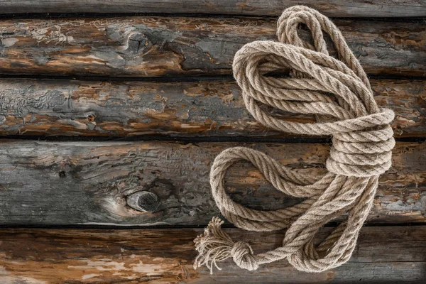 Top view of tied nautical rope on grunge wooden surface — Stock Photo