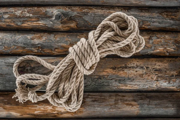 Top view of tied nautical rope on grunge wooden surface — Stock Photo