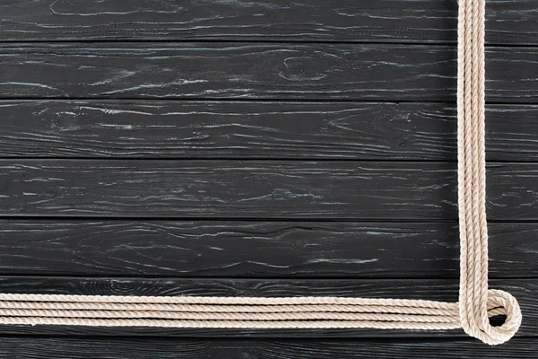 Top view of arranged white marine ropes on dark wooden tabletop — Stock Photo