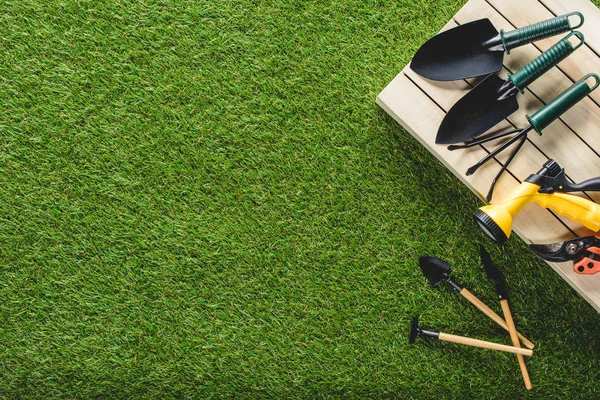 Top view of gardening tools and equipment on grass — Stock Photo