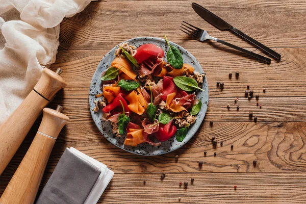 Top view of delicious salad with mussels, vegetables and jamon on wooden table — Stock Photo