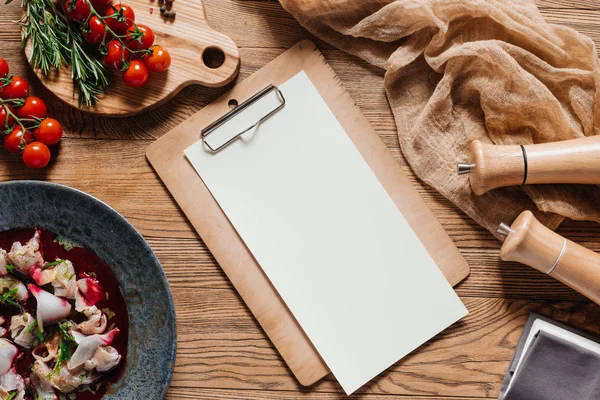 Top view of blank paper on clipboard and gourmet Ceviche with dorado on wooden table — Stock Photo