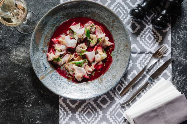 Top view of delicious dish with dorado and glass of wine on table — Stock Photo