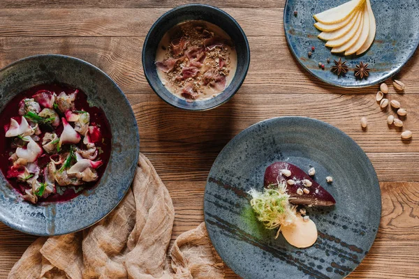 Top view of fresh gourmet dishes on wooden table — Stock Photo