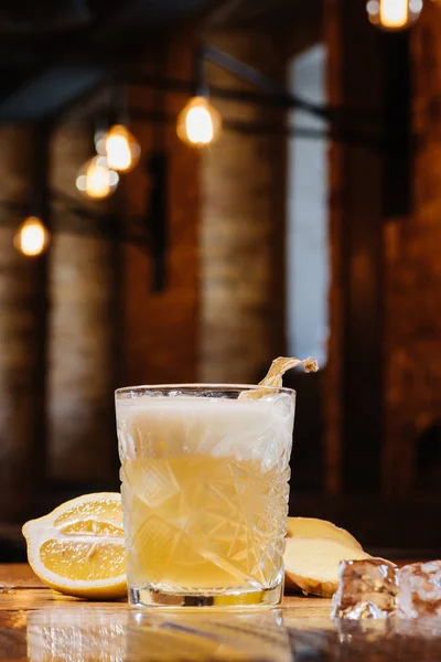 Close-up view of glass with ginger nail cocktail on table — Stock Photo