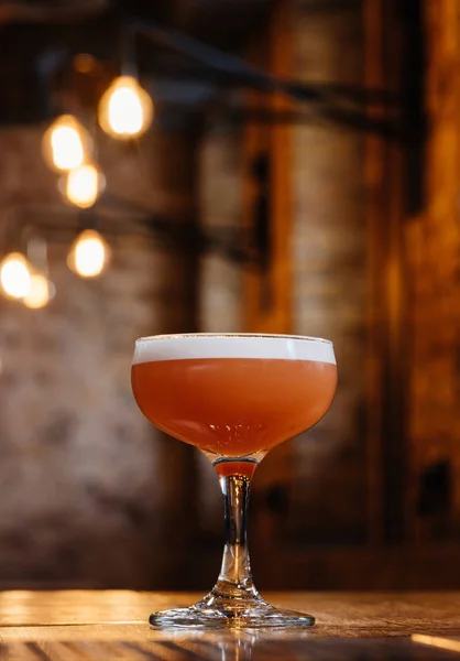 Close-up view of conchita cocktail in glass on wooden table — Stock Photo