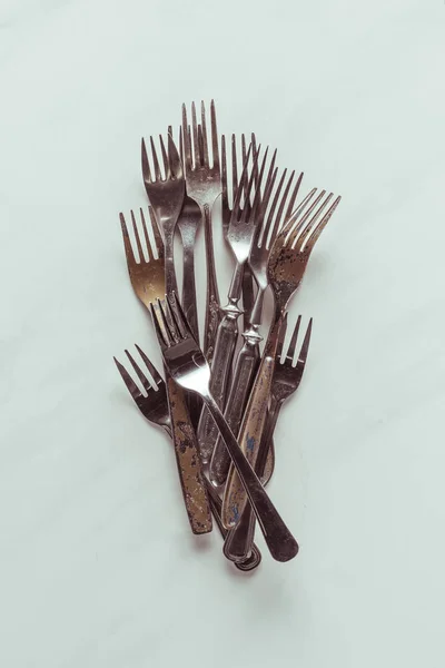 Old metal forks on white background — Stock Photo