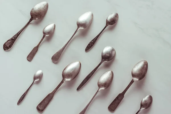 Various vintage spoons on white table — Stock Photo