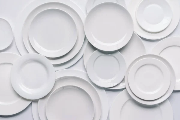 White plates composition on white background — Stock Photo