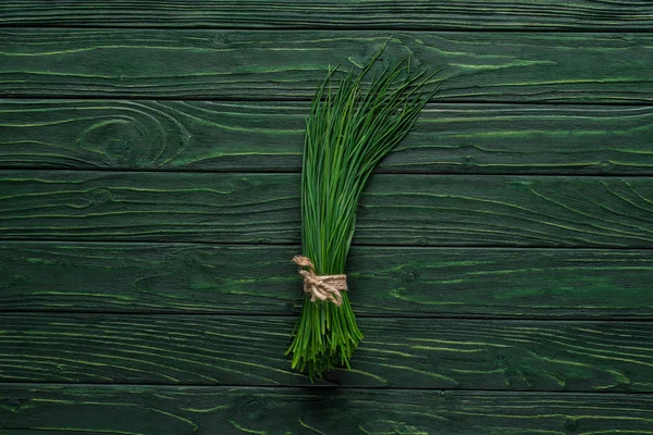 Top view of bunch of chives on wooden table, healthy eating concept — Stock Photo