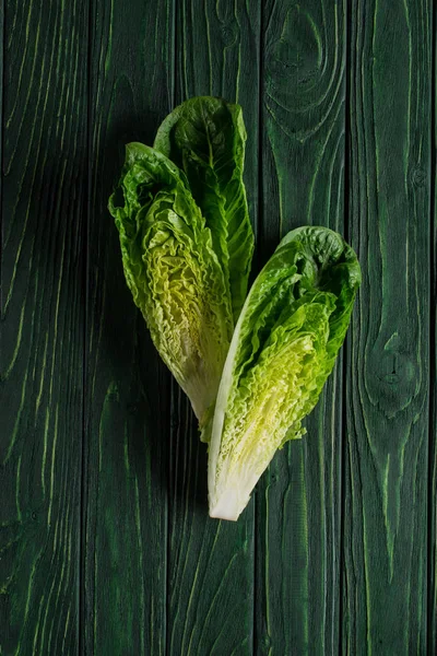 Top view of cut green cabbage on wooden table, healthy eating concept — Stock Photo