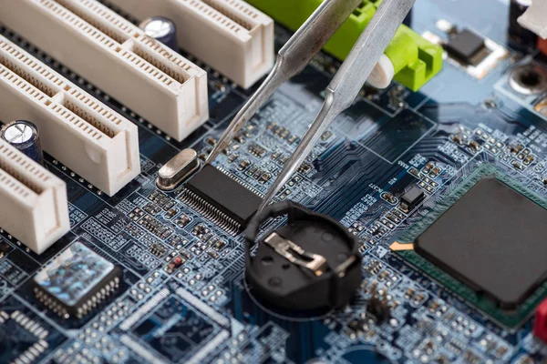 Fixing standard motherboard with microchips and schemes — Stock Photo