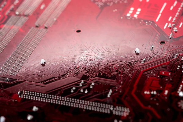 Red computer motherboard with integrated elements — Stock Photo