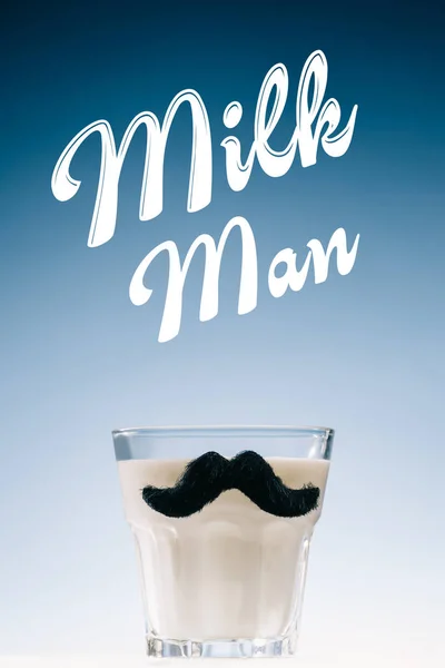 Glass of milk with mustaches and Milk man inscription isolated on blue background — Stock Photo