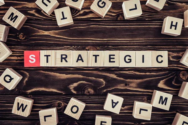 Top view of strategy inscription made of wooden blocks on brown wooden surface — Stock Photo