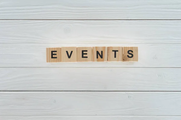 Top view of events word made of wooden blocks on white wooden surface — Stock Photo