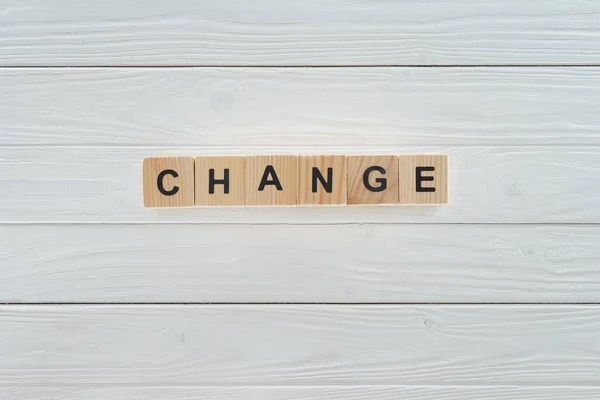 Close up view of change word made of wooden cubes on white wooden tabletop — Stock Photo