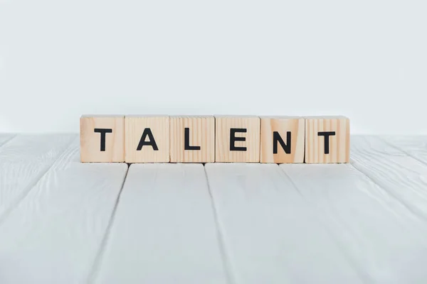 Close up view of talent word made of wooden cubes on white wooden tabletop — Stock Photo