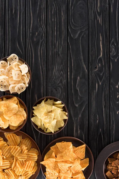 Top view of various junk food and snacks on wooden table — Stock Photo