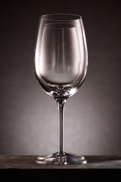 Two empty wineglasses in row on black — Stock Photo