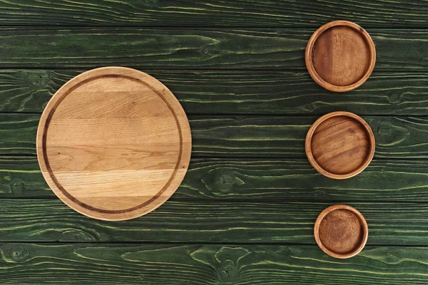 Top view of various types of wooden round cutting boards on table — Stock Photo