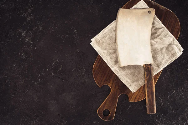 Top view of butcher axe on sackcloth and wooden cutting board — Stock Photo