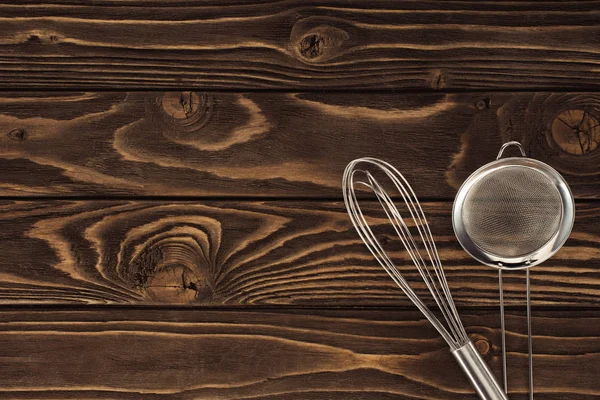 Vista superior de batedor e peneira na mesa de madeira — Fotografia de Stock