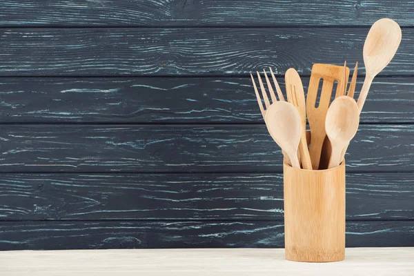 Vue rapprochée des ustensiles de cuisine devant le mur en bois — Photo de stock