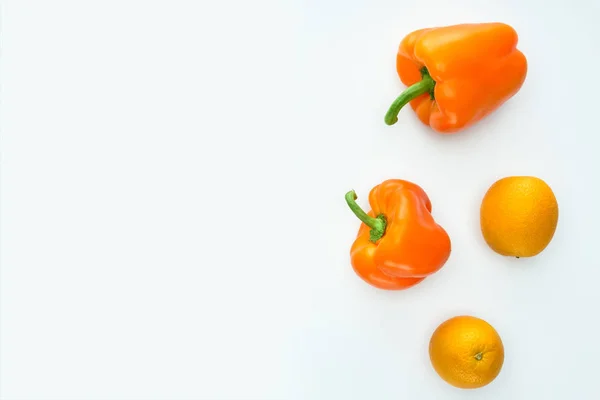 Vista superior de pimentas laranja e laranjas isoladas em branco — Fotografia de Stock