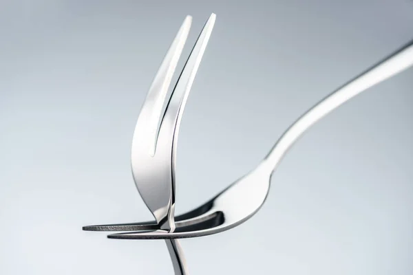 Shiny forks with two tines isolated on grey — Stock Photo