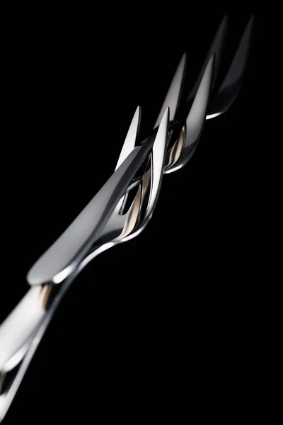 Stainless forks with two tines isolated on black — Stock Photo