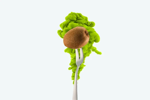 Kiwi on fork and green ink isolated on white — Stock Photo