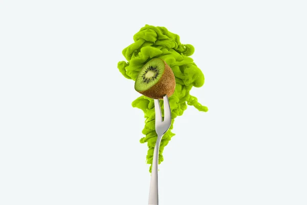 Half of kiwi on fork and green ink isolated on white — Stock Photo