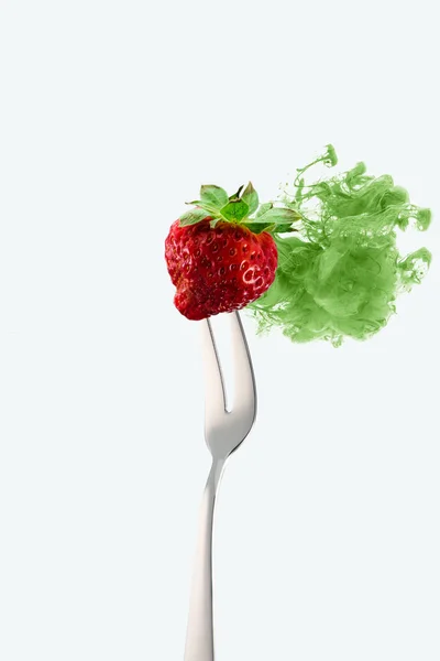 Strawberry on fork and green ink isolated on white — Stock Photo