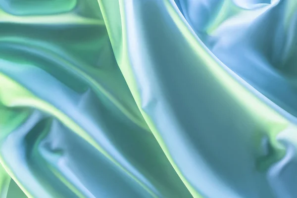 Toned picture of green and blue soft silk cloth as backdrop — Stock Photo