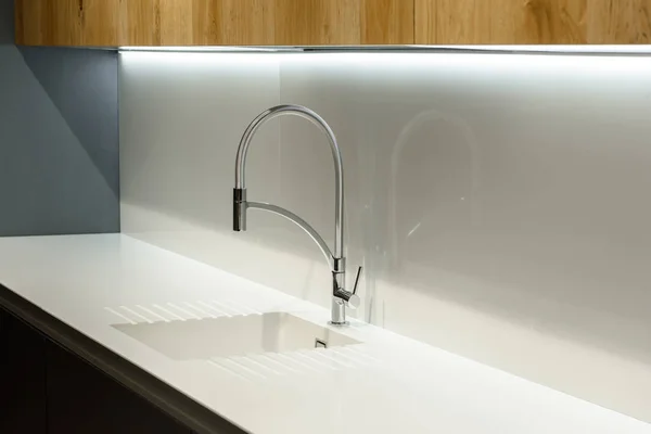 Close-up view of white sink in renovated kitchen — Stock Photo