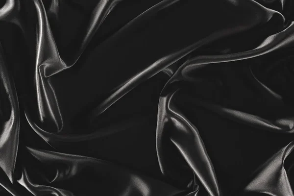 Plein cadre de tissu de soie élégant noir comme fond — Photo de stock