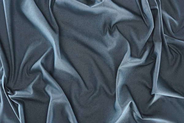 Vista de cerca de la tela de seda azul oscuro arrugado como fondo - foto de stock