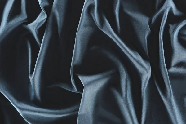 Close up view of crumpled dark blue silk fabric as background — Stock Photo