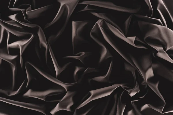 Full frame of folded dark silk cloth as background — Stock Photo