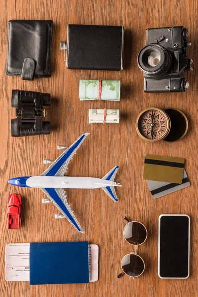 Top view of different travel attributes on wooden surface — Stock Photo