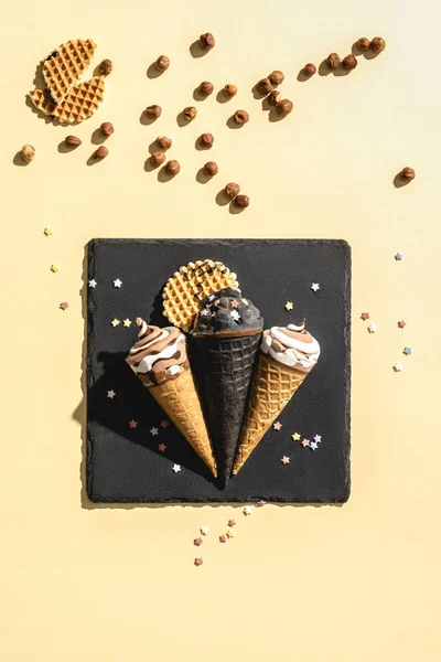 Elevated view of black and white ice cream on yellow — Stock Photo