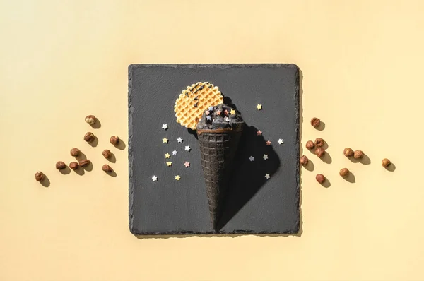 Top view of black ice cream on yellow — Stock Photo